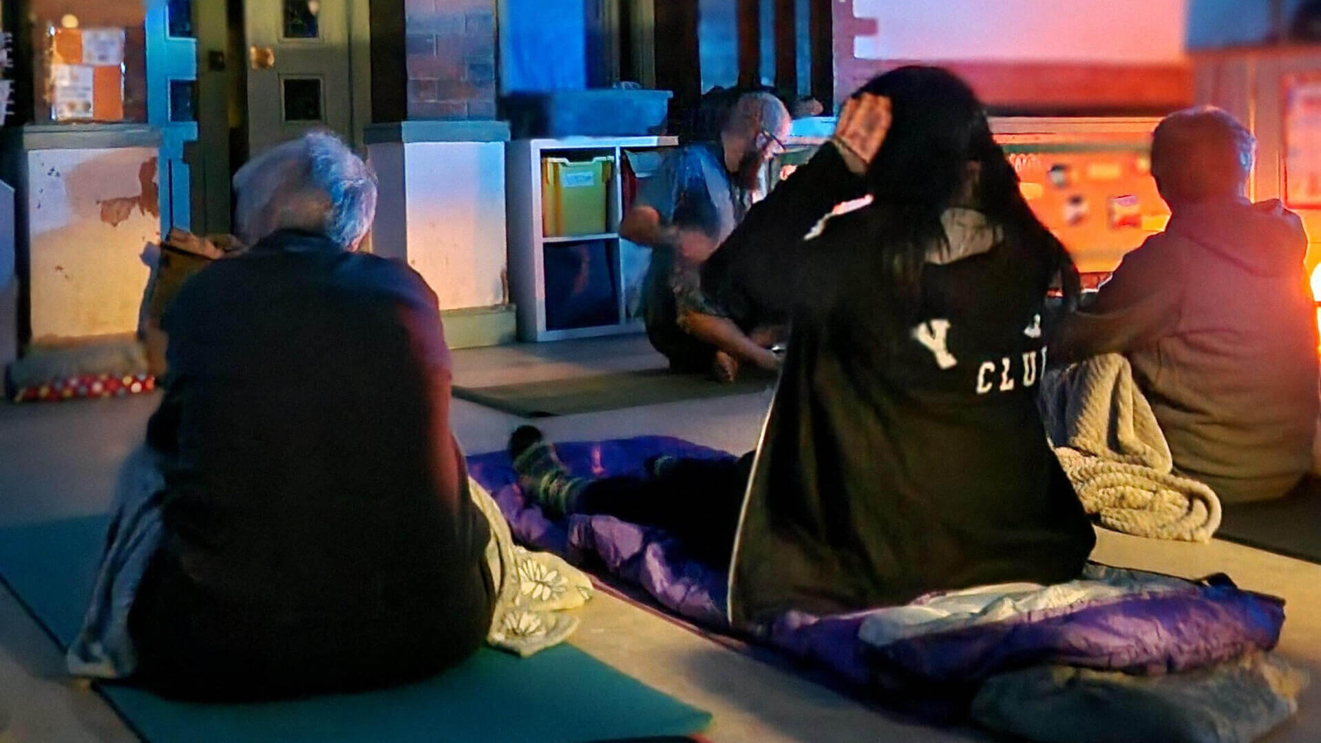 A women practicing Shavasana during a Yoga Nidra session